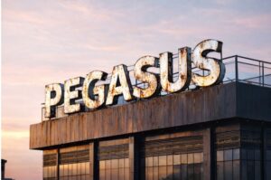 Large rustic vintage Pegasus rooftop signage with weathered metal finish and internal LED illumination during sunset.