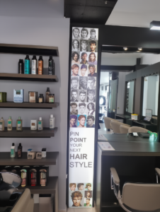 Hairstyle references & text displayed in an LED frame in a salon 